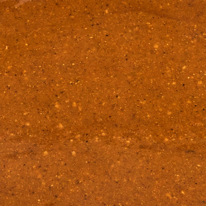 A textured reddish-brown surface with small scattered particles creates a warm and earthy visual.