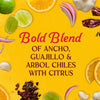 This image features the text Bold Blend of Ancho Guajillo &amp; Arbol Chiles with Citrus surrounded by limes oranges red onions garlic and dried chiles.