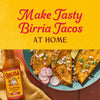 A bottle of Cholula Birria Cooking &amp; Simmer Sauce is featured next to a plate of birria tacos with the text Make Tasty Birria Tacos at Home above.