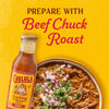 A bottle of Cholula Birria Cooking &amp; Simmer Sauce is featured next to a bowl of beef chuck roast suggesting a recipe idea.