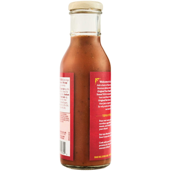 A bottle of Cholula Original Taco Topping Sauce with a red label displaying nutritional information and serving suggestions.