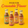 Four bottles of Cholula cooking and simmer sauces in different flavors are displayed against a yellow background.