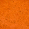 A close-up shot of a vibrant orange textured surface possibly a sauce or paste.