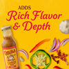 A bottle of Cholula Fajita Cooking &amp; Simmer Sauce is surrounded by fresh ingredients like peppers onions and garlic with the text ADDS Rich Flavor &amp; Depth above.