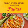 A plate of chicken fajitas with peppers and onions accompanied by bowls of cilantro salsa and avocado perfect for a delicious and customizable meal.