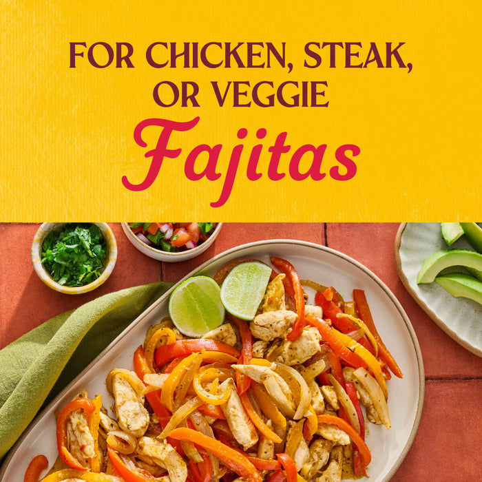 A plate of chicken fajitas with peppers and onions accompanied by bowls of cilantro salsa and avocado perfect for a delicious and customizable meal.