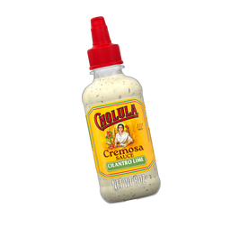 Bottle of Cholula Cremosa Sauce with a red cap on a white background