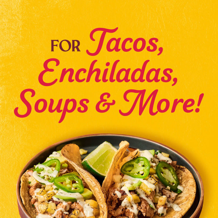 A plate of tacos enchiladas soups and more is displayed against a yellow background.