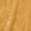 A close-up shot of a creamy orange-colored sauce with small red and black specks.