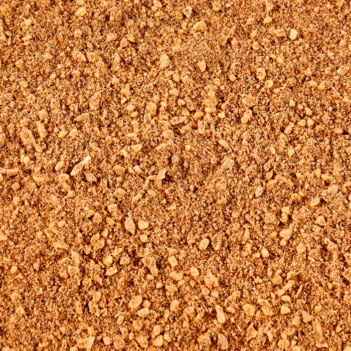 A close-up view of a reddish-brown granular surface, possibly representing a soil or aggregate material.