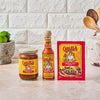 Eight bottles of Cholula hot sauce in different flavors are lined up on a counter.