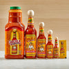 Six bottles of Cholula Original Hot Sauce in various sizes, from a small packet to a large bottle.