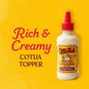 A bottle of Cholula Crema Cotija Topper is displayed next to the words Rich &amp; Creamy Cotija Topper.