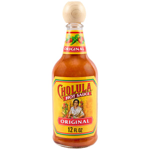 A bottle of Cholula Original Hot Sauce, featuring its iconic yellow label with a woman in traditional attire, the brand name, and Original 12 FL OZ, all beneath a distinctive wooden cap.