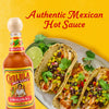 A bottle of Cholula Original Hot Sauce is prominently displayed next to a plate of three delicious chicken tacos garnished with corn and black bean salsa and fresh cilantro, set against a bright yellow background.