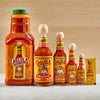 A lineup of Cholula Original Hot Sauce products in various sizes, including a large jug, several glass bottles with wooden caps, and a small packet, all featuring the iconic yellow label.