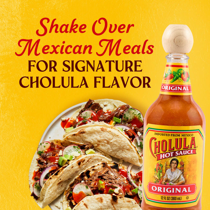 A bottle of Cholula Original Hot Sauce stands next to a plate of tacos, with text encouraging shaking it over Mexican meals for signature flavor.