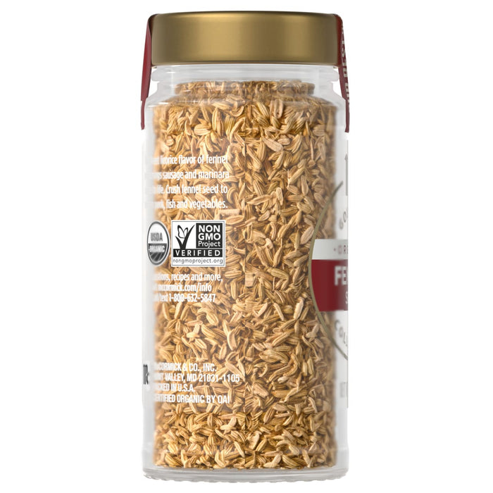 A jar of McCormick fennel seed with a gold lid and a red label.
