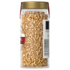 A jar of organic fennel seeds with a gold lid and a label with a barcode.