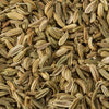 A close-up view of dried fennel seeds, showcasing their elongated shape and ridged texture.