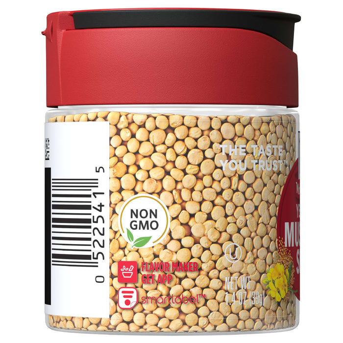 A jar of yellow mustard seeds with a red lid and a label that says The taste you trust and Non GMO.