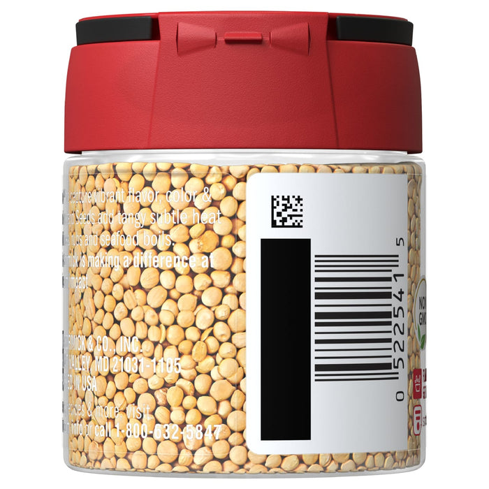 A glass jar of McCormick Mustard Seeds with a red lid.