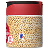 A glass jar of McCormick Yellow Mustard Seeds with a red lid.