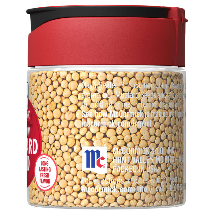 A glass jar of McCormick Yellow Mustard Seeds with a red lid.