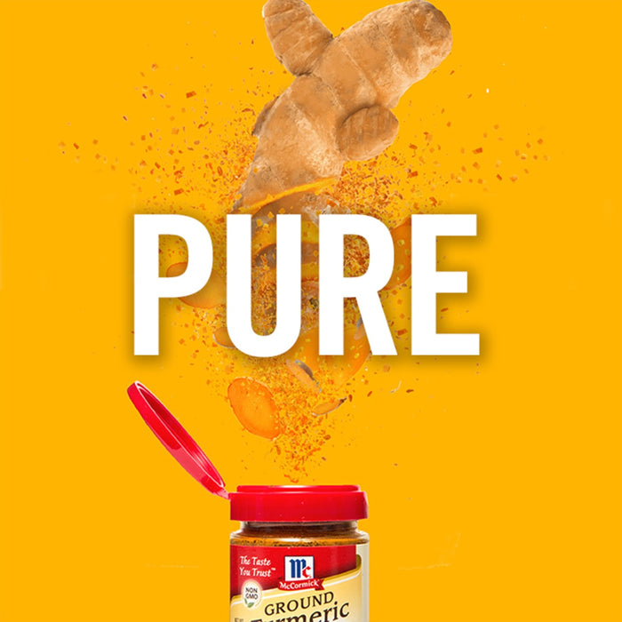 A McCormick ground turmeric spice jar with a burst of turmeric root pieces and powder around it, with the word PURE in large white letters.