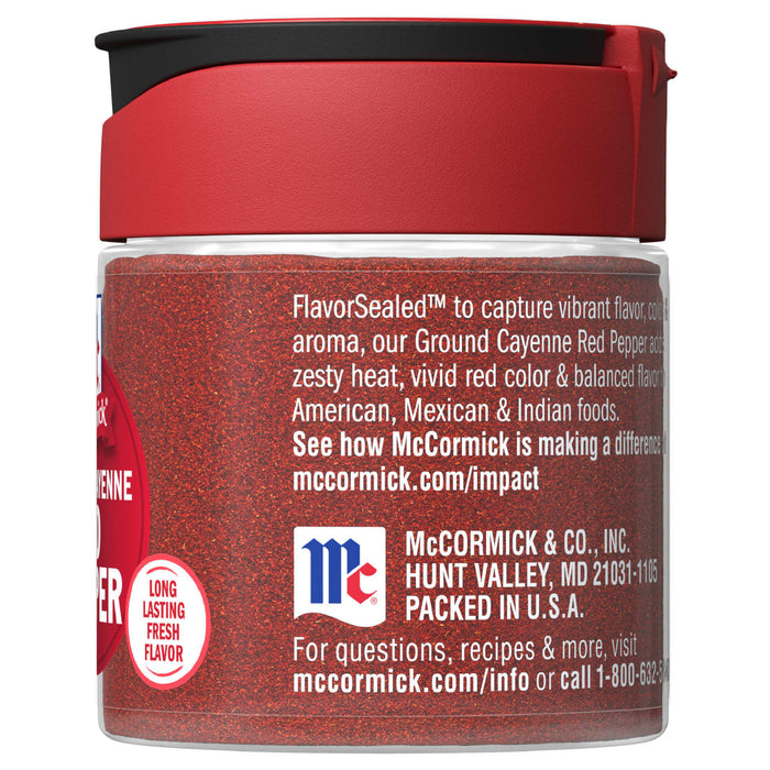 A McCormick Ground Cayenne Red Pepper spice jar with a red lid and a red label.