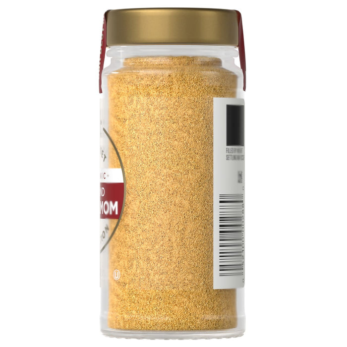 A jar of Simply Organic Ground Cardamom is shown, filled with a yellow powder and sealed with a gold lid.