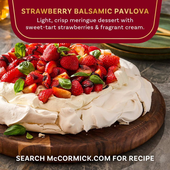 A Strawberry Balsamic Pavlova dessert from McCormick, featuring a light, crisp meringue topped with sweet-tart strawberries and fragrant cream.