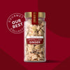 A jar of crystallized ginger from the Our Best Collection gourmet line is displayed against a red background.