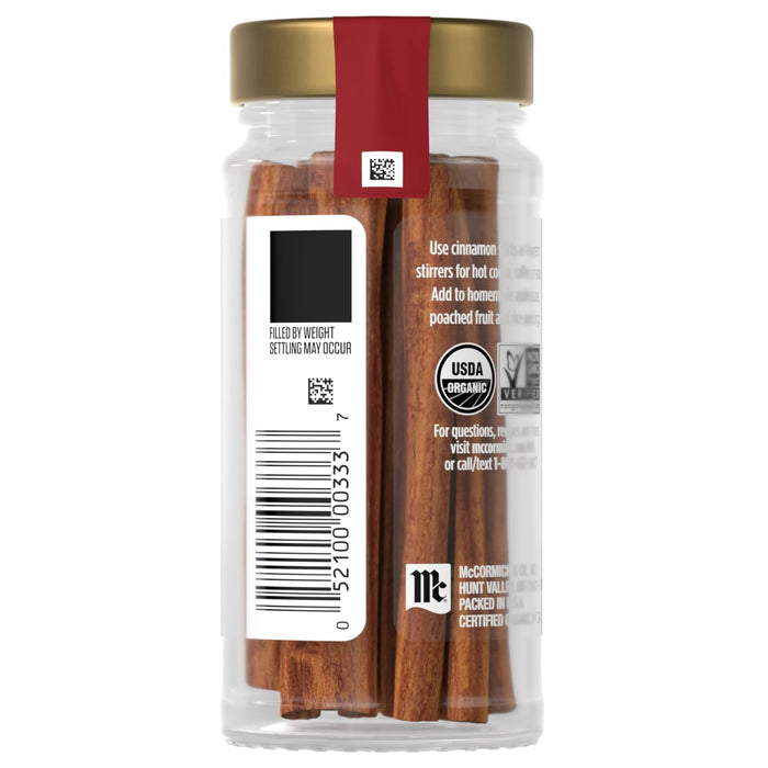 A jar of McCormick organic cinnamon sticks with a gold lid and red label.