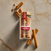 A jar of Royal Cinnamon Sticks is displayed on a marble surface with scattered cinnamon sticks.