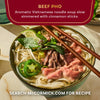 McCormick's Beef Pho, an aromatic Vietnamese noodle soup stew simmered with cinnamon sticks, is shown in a green bowl with chopsticks.
