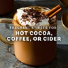 A mug of hot cocoa topped with whipped cream, chocolate shavings, and a cinnamon stick, suggesting a fragrant and flavorful beverage.