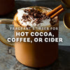 A mug of hot cocoa topped with whipped cream, chocolate shavings, and a cinnamon stick, suggesting a fragrant and flavorful beverage.