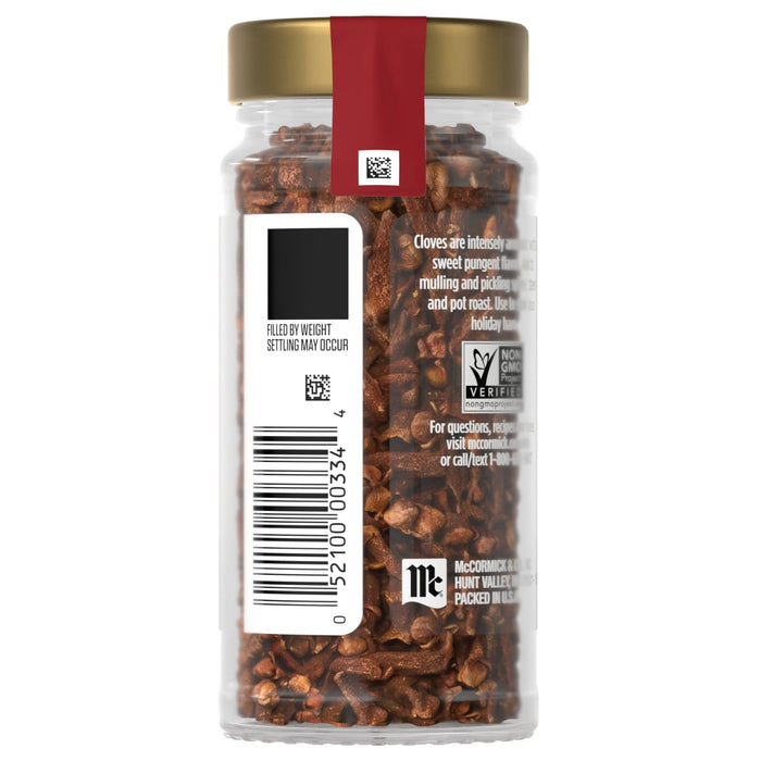 A jar of McCormick cloves with a gold lid and a red label.
