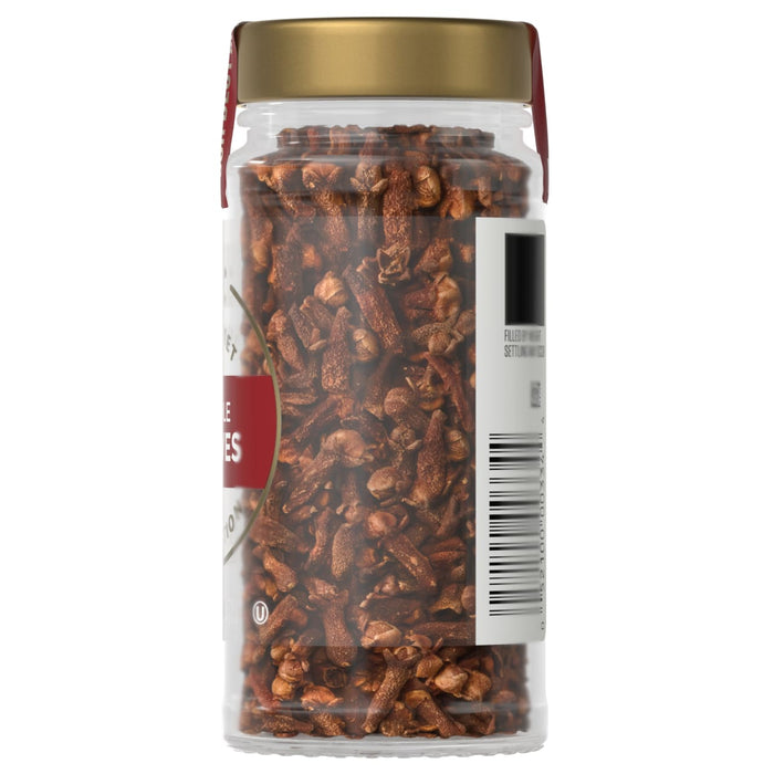 A jar of McCormick Whole Cloves is shown, filled with brown cloves and sealed with a gold lid.