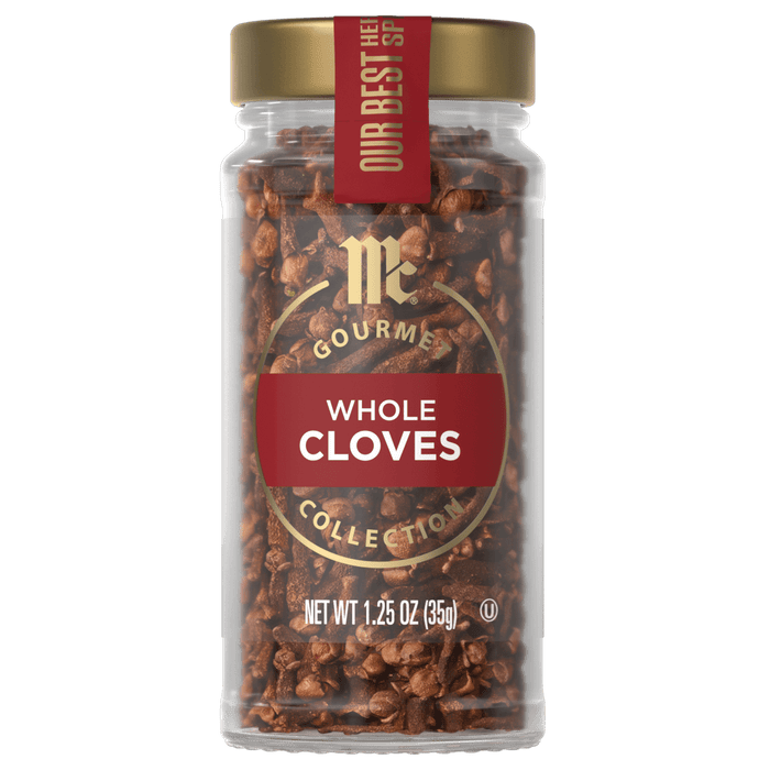 A jar of McCormick Gourmet Whole Cloves Collection is displayed, showcasing the brand and product.