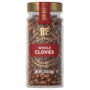 A jar of McCormick Gourmet Whole Cloves Collection is displayed, showcasing the brand and product.