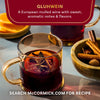 Aromatic Gluhwein, a European mulled wine from McCormick, is served in glass mugs with orange slices and spices.