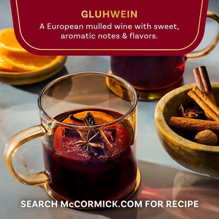 Aromatic Gluhwein, a European mulled wine from McCormick, is served in glass mugs with orange slices and spices.