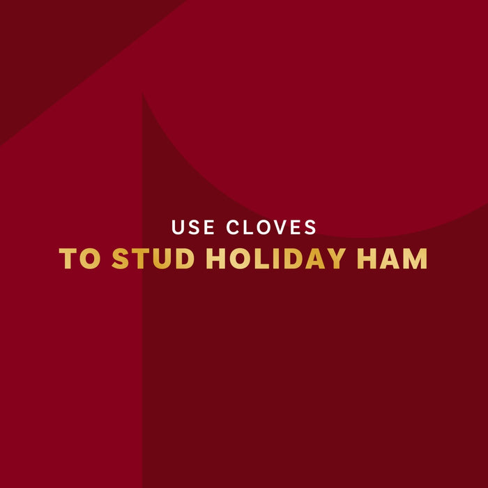 A festive red background with text that encourages the use of cloves to stud a holiday ham.