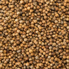 A close-up shows a pile of coriander seeds, showcasing their round shape and light brown color.