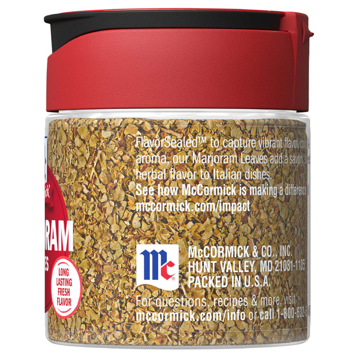 A McCormick Marjoram spice jar with a red lid and a clear glass body.