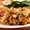 A close up of a plate of stuffing with cranberries, apples, and celery.