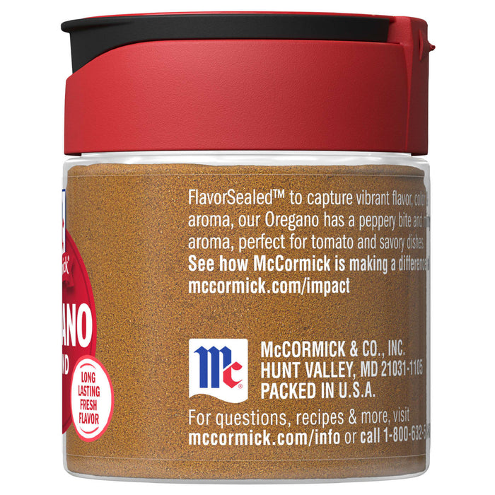A McCormick jar of dried oregano with a red lid.