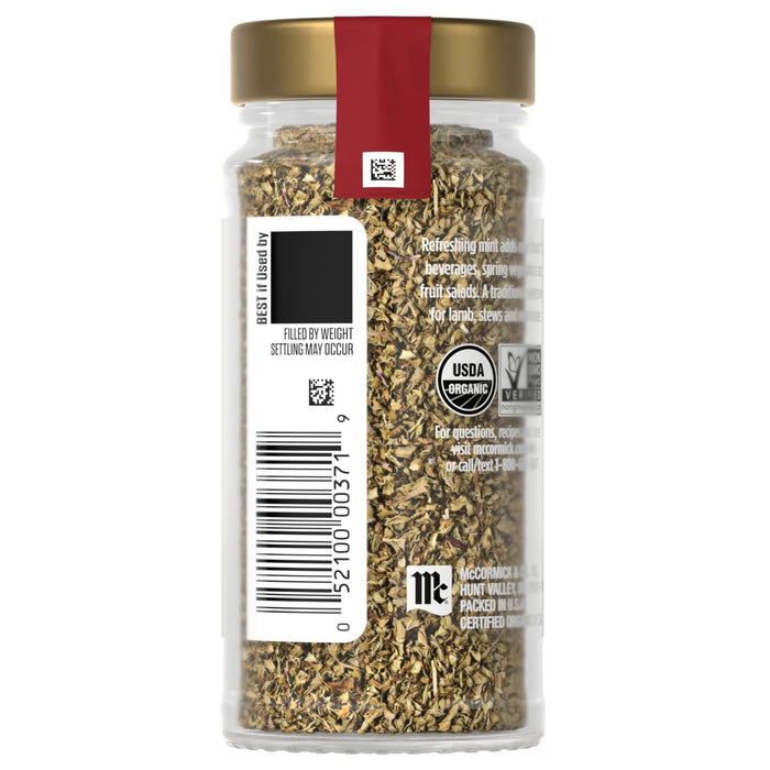 A jar of McCormick organic dried basil with a gold lid and a red label.